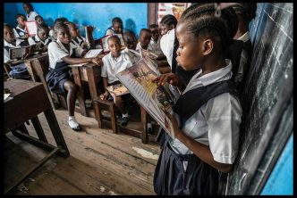 A student in a Monrovia public school reading a book aloud