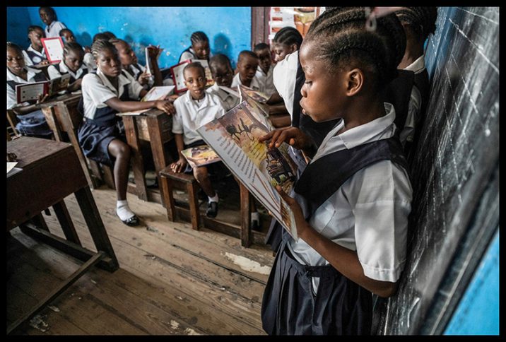 A student in a Monrovia public school reading a book aloud